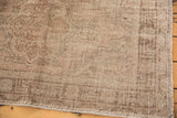 Vintage Distressed Oushak rug detail: tone-on-tone sand hues, worn floral motifs, intact selvage.