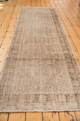 Oushak runner's distressed pile texture with even wear and secure fringe.
