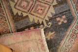 Textural detail of vintage Oushak rug with worn pile, visible foundation, and secured side.