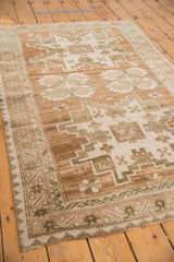 Abrashed field and geometric patterns in coffee brown, antique ivory, and dark moss.