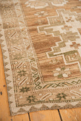 Vintage Distressed Oushak rug corner with coffee brown, moss green, and sand geometric border.