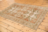 Vintage distressed Oushak rug corner detail, abrashed coffee brown, antique ivory, dark moss.