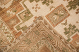 Close-up of low pile geometric design on distressed Oushak rug with hand-knotted reverse.