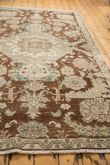 Distressed brown and beige vintage Sparta rug fringe, featuring intricate border and worn texture.