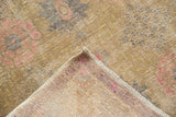 Vintage distressed Oushak rug's hand-knotted foundation and worn pile texture, blush pink.