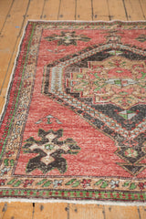 Textured cherry red Oushak rug with even wear, geometric navy, powder blue, green patterns.