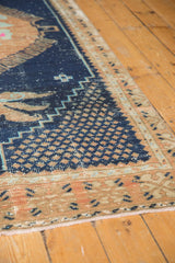 Distressed indigo blue field with beige and powder blue geometric motifs on Oushak rug.