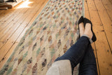 Distressed vintage Oushak runner, featuring a playful lattice diamond pattern with varied soft color fills.