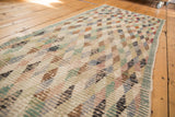 Distressed Oushak runner with textural diamond lattice pattern and soft, varied colors.
