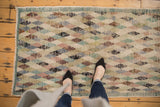 Distressed vintage Oushak runner with playful ivory, blush, and denim diamond lattice.