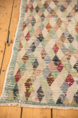 Distressed Oushak rug runner; textural diamond lattice, foundation visible through pile, intact selvage.