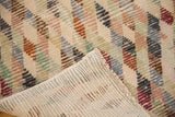 Folded distressed Oushak runner showing colorful diamond pattern, worn pile, woven foundation, and selvage.