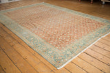 Vintage Sivas carpet corner, highlighting distressed terracotta Herati motif and dusty teal border.