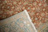 Distressed vintage Sivas carpet with terracotta pile, showing intricate Herati weave on reverse and fringe.