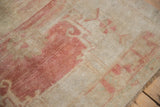 Close-up of distressed Oushak runner pile, abrashed ivory, blush tones, and secured side.