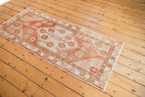 Distressed vintage Oushak runner, showcasing faded blush, rose, ivory floral texture.