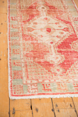 Blush, ivory, and pale aqua distressed vintage Oushak runner geometric border and fringe.