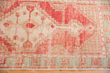 Distressed vintage Oushak runner with red, ivory, and aqua geometric border, fringe.