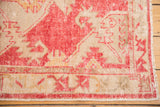 Fringed corner of distressed Turkish Oushak rug, raspberry red and ivory wool pattern.