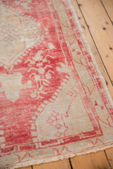 Distressed raspberry red and pale beige floral blossoms with fringed edge.