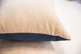 Throw pillow side seam contrasting natural linen and luxurious navy velvet.