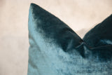 Detailed texture of a peacock teal blue velvet throw pillow's soft pile.