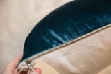 Luxe Velvet Throw Pillow's brass zipper, rich peacock teal velvet, and natural linen.