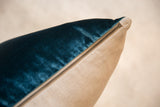 Velvety peacock teal and natural linen throw pillow with brass zipper.