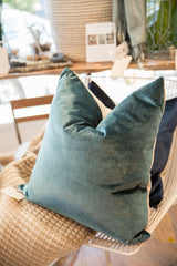 Luxe velvet throw pillow in peacock teal blue with a soft texture.