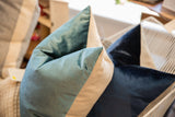 Peacock teal velvet throw pillow corner with natural linen back.