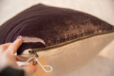 Hand opening brass zipper on plum velvet and natural linen pillow.