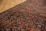 Vintage Hamadan runner close-up: Herati motif, Serbend border, navy, red, orange, and tattered edge.