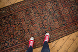 Detail of vintage Hamadan runner showing allover Herati motif, Serbend border, and knot wear.