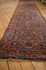 Tattered end of vintage Hamadan runner, highlighting its vibrant Herati and Serbend patterns.