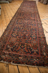 Tattered end and Serbend border of the Vintage Hamadan runner, highlighting its worn Herati pattern.