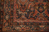 Vintage Hamadan rug shows intricate Serbend border, Herati field, and wear to knot heads.
