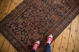 Vintage Hamadan runner corner, allover Herati motif, Serbend border, in navy, red, and visible wear.