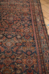 Hamadan runner detail: worn Herati pattern, Serbend border, and exposed foundation in navy, red.