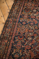 Close-up of vintage hand knotted Hamadan runner, worn Herati motif, Serbend border, navy, red, exposed foundation.
