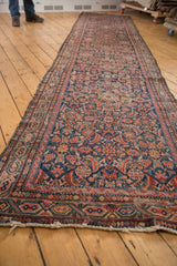 Tattered fringe and worn side of a vintage Hamadan runner, revealing Herati details.
