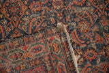 Vintage Hamadan rug corner with tattered fringe, worn Herati pattern, and Serbend border reverse.