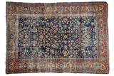 Hand-knotted vintage Persian Mahal carpet with worn navy blue floral field and terra cotta border.