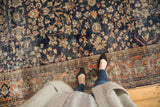 Worn navy floral field and terra cotta vine palmette border on a vintage Mahal rug.