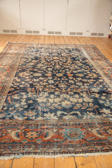 Vintage Mahal rug's hard-worn terra cotta vine palmette border and navy floral field.