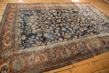 Vintage Mahal carpet: terra cotta rust meandering palmette border and navy floral field with hard wear.