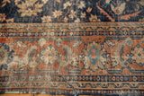 Textured terra cotta palmette border and faded navy field of the vintage Mahal.