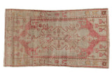 Distressed vintage Oushak rug with pale blush, beige medallion and scrolling motifs, 2'8