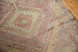 Oushak runner detail with serrated diamond, hook motifs, and abrashed dusty aubergine.