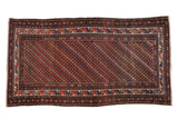 Vintage Kurdish rug with allover diagonal rows of blossoms in chocolate, navy, brick, and ivory. 3'6