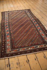 Repeating diagonal blossom rows with alternating chocolate brown, brick red, and navy tones.